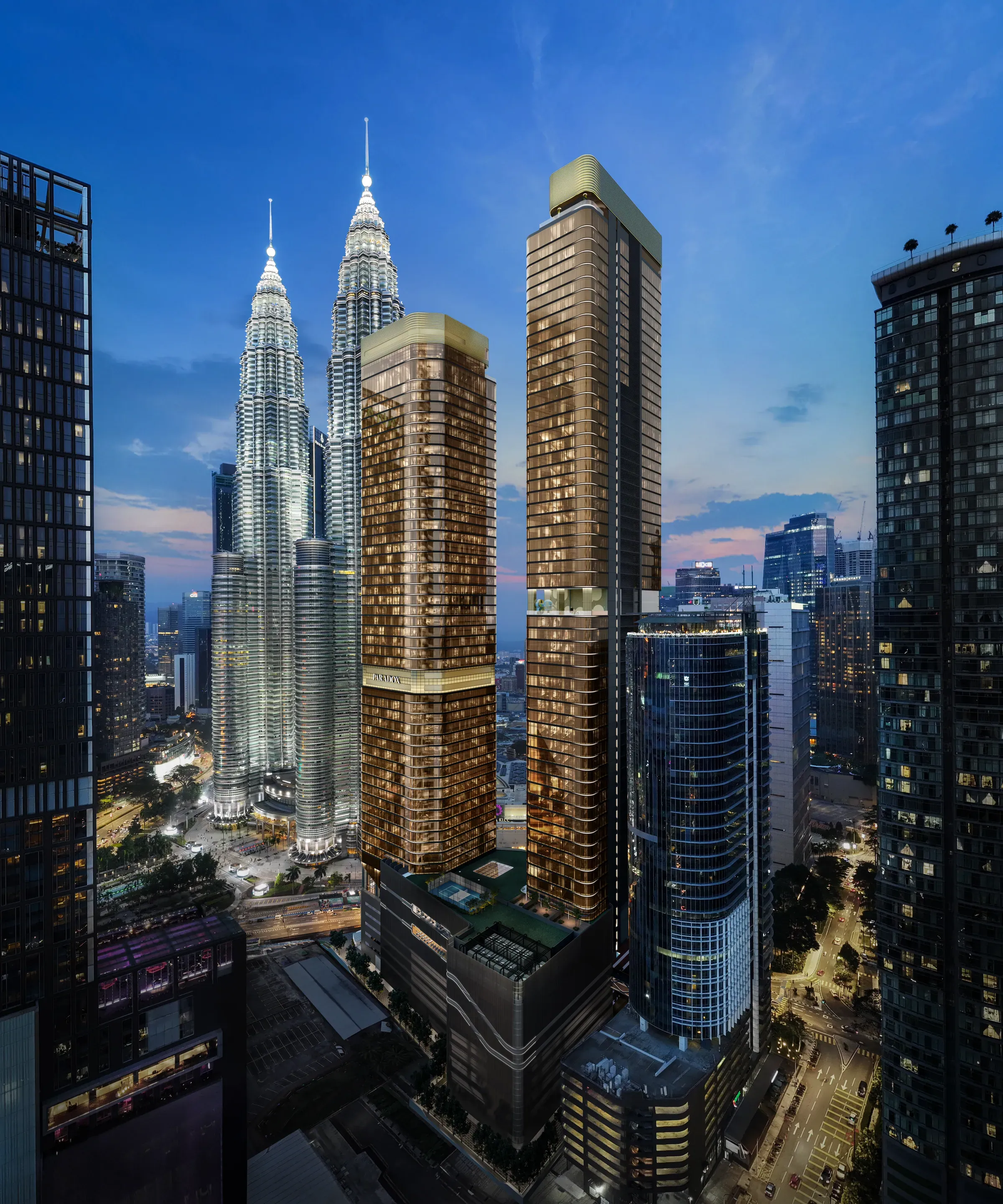 CloutHaus KL City Centre lit up at night against the Kuala Lumpur skyline