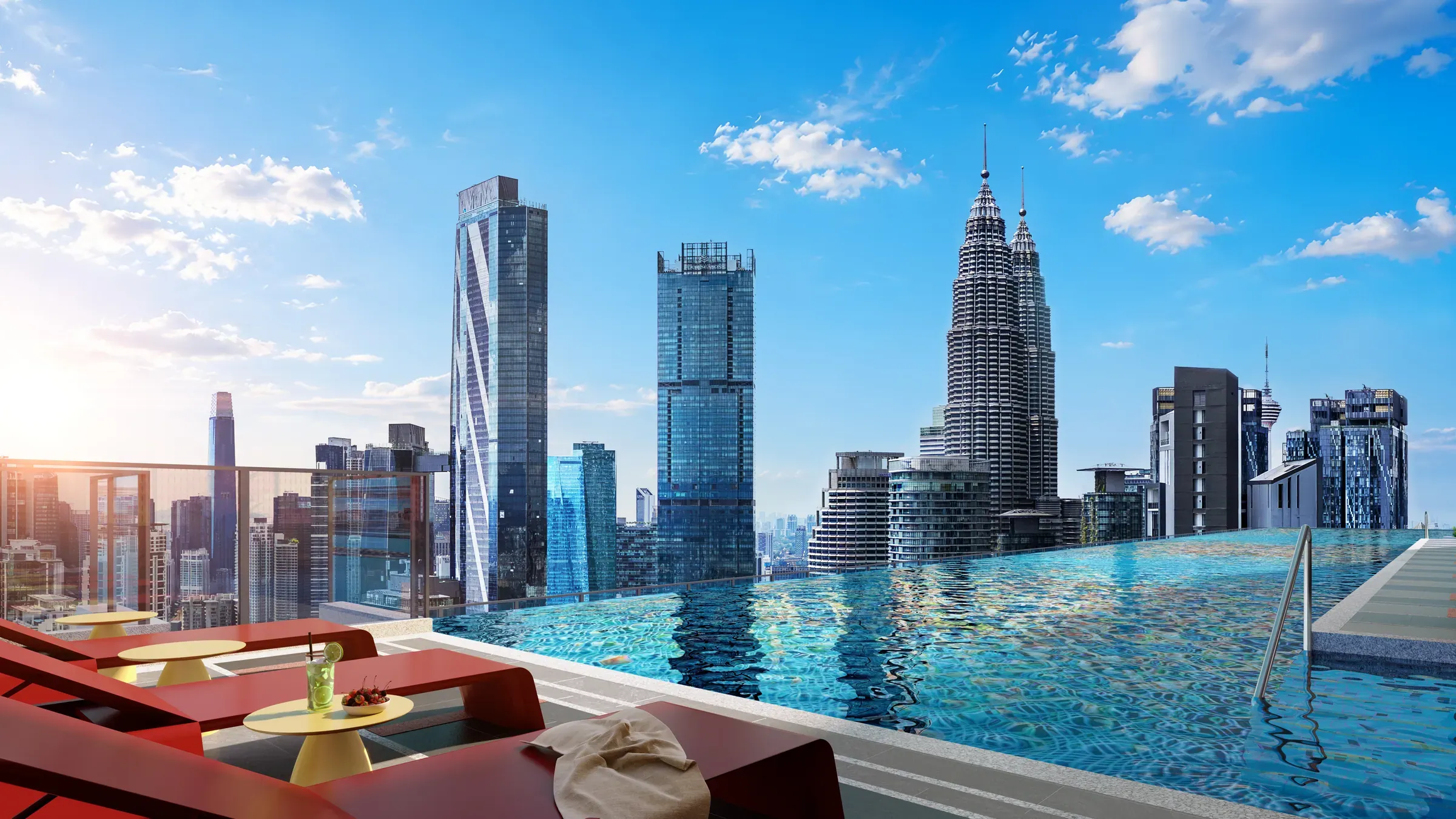 Rooftop infinity pool with sun loungers under a blue sky